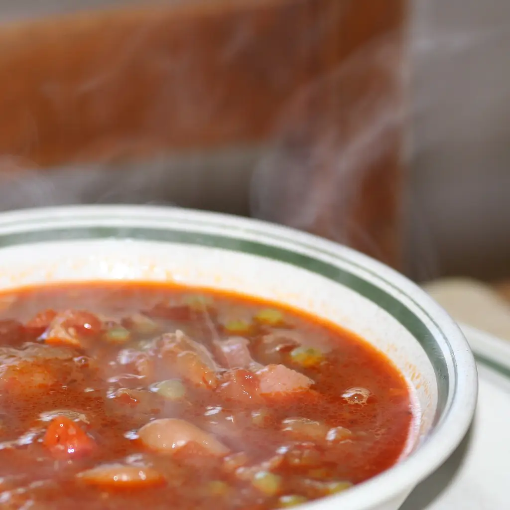 A steaming bowl of ham and butter-bean soup.