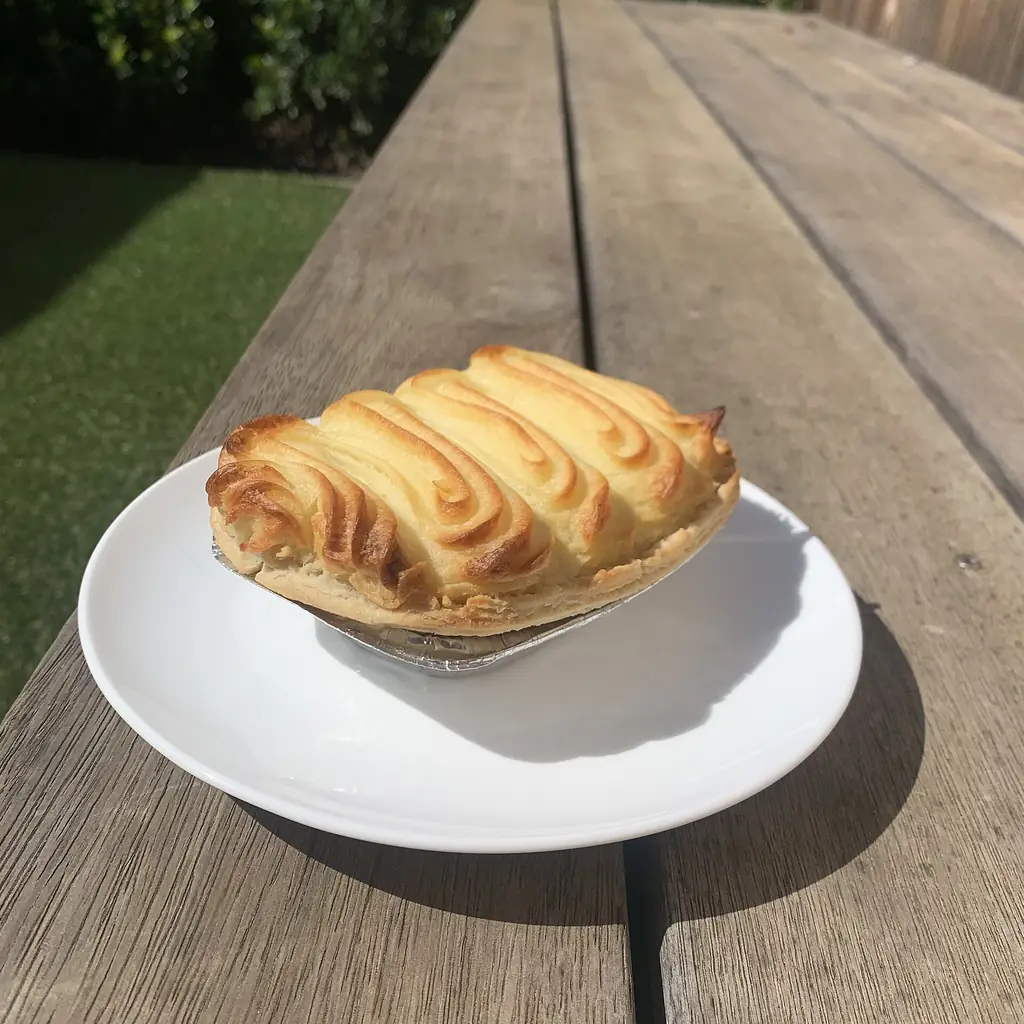 A meat pie under mashed potatoes