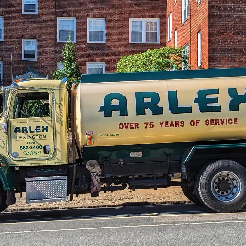 A heating oil delivery truck parked on a residential street.